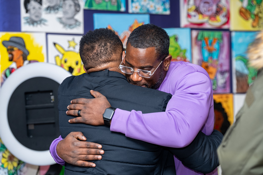 Two brothers embracing at Burger Bar