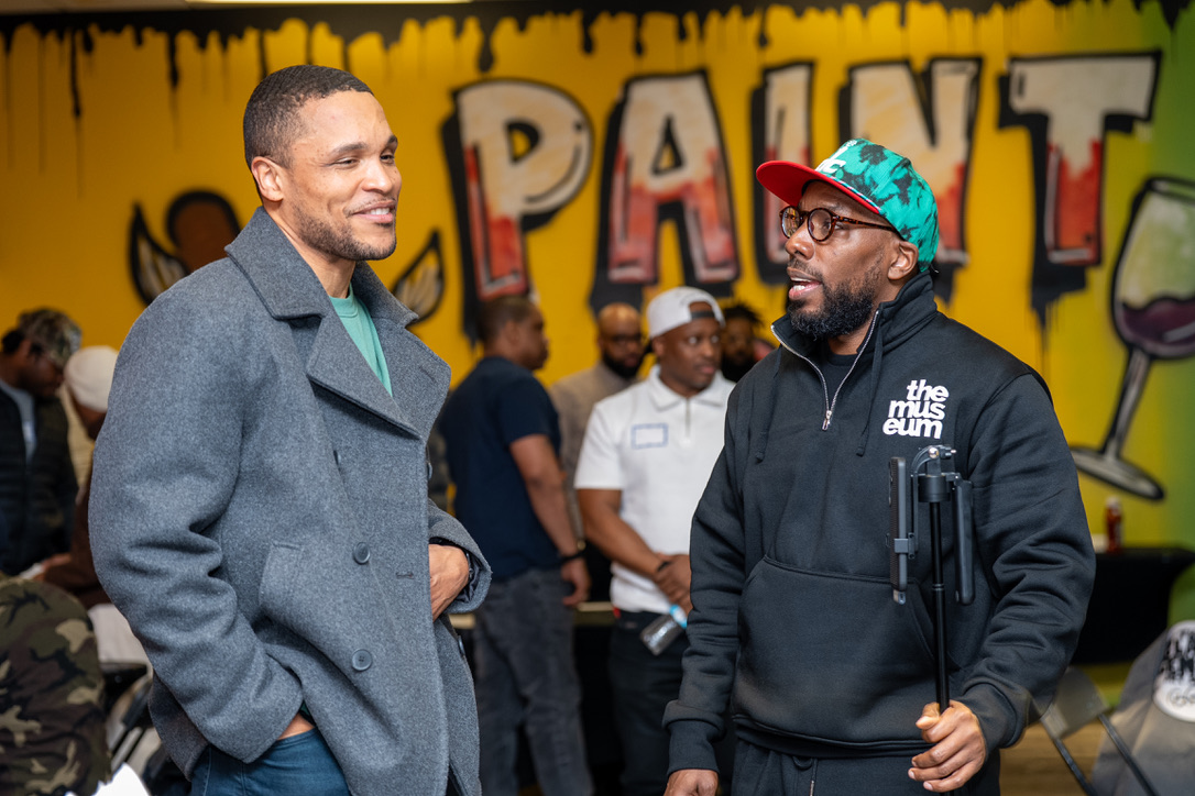 Two brothers connecting in front of the Paint N Sip mural
